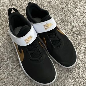 Brand new never worn black, white and gold Nike shoes